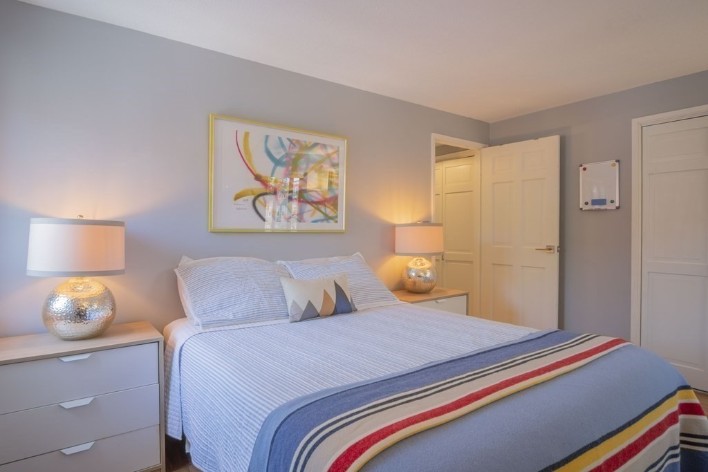 9 Barton Square, Unit 201 Salem, MA 01970 - Photo 20 of 42 a bedroom with a bed and lamp