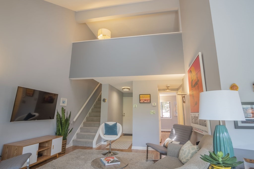 9 Barton Square, Unit 201 Salem, MA 01970 - Photo 2 of 42 a living room with furniture and a flat screen tv