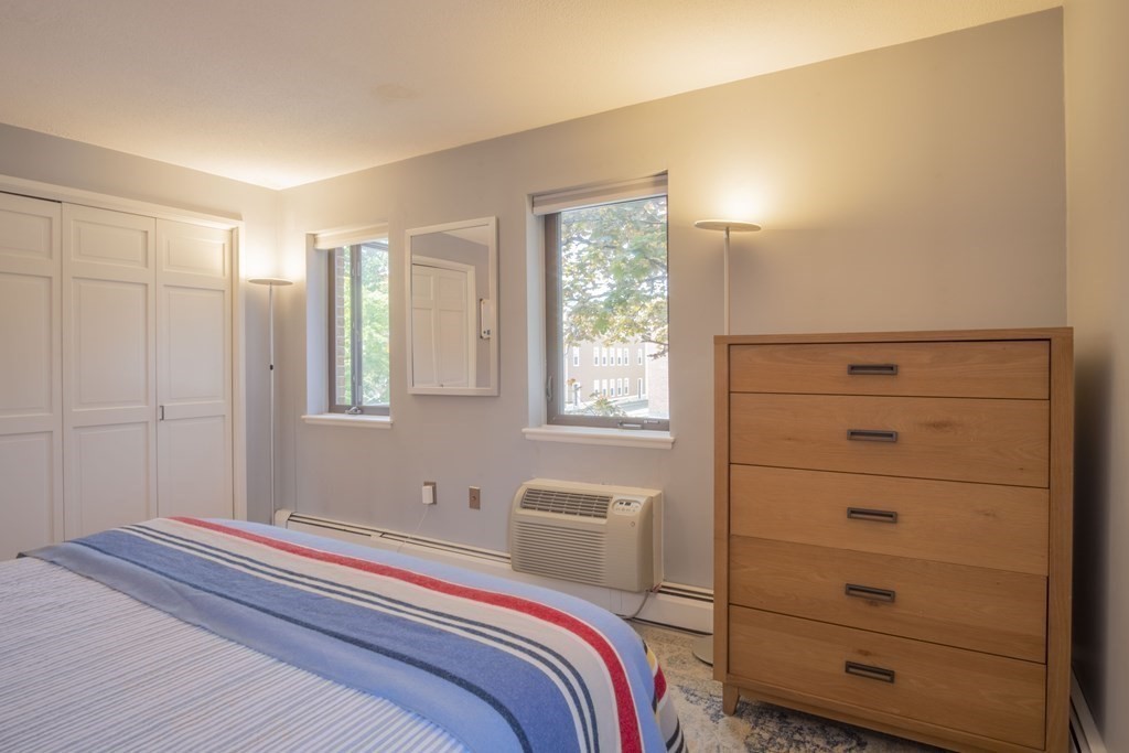 9 Barton Square, Unit 201 Salem, MA 01970 - Photo 21 of 42 a bedroom with a bed and a mirror