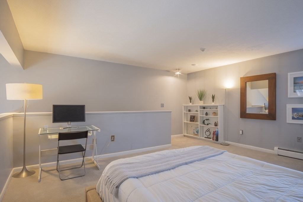 9 Barton Square, Unit 201 Salem, MA 01970 - Photo 28 of 42 a bedroom with a bed and a flat screen tv