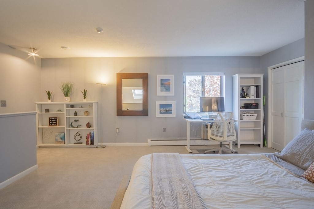 9 Barton Square, Unit 201 Salem, MA 01970 - Photo 29 of 42 a spacious bedroom with a bed and a cabinets