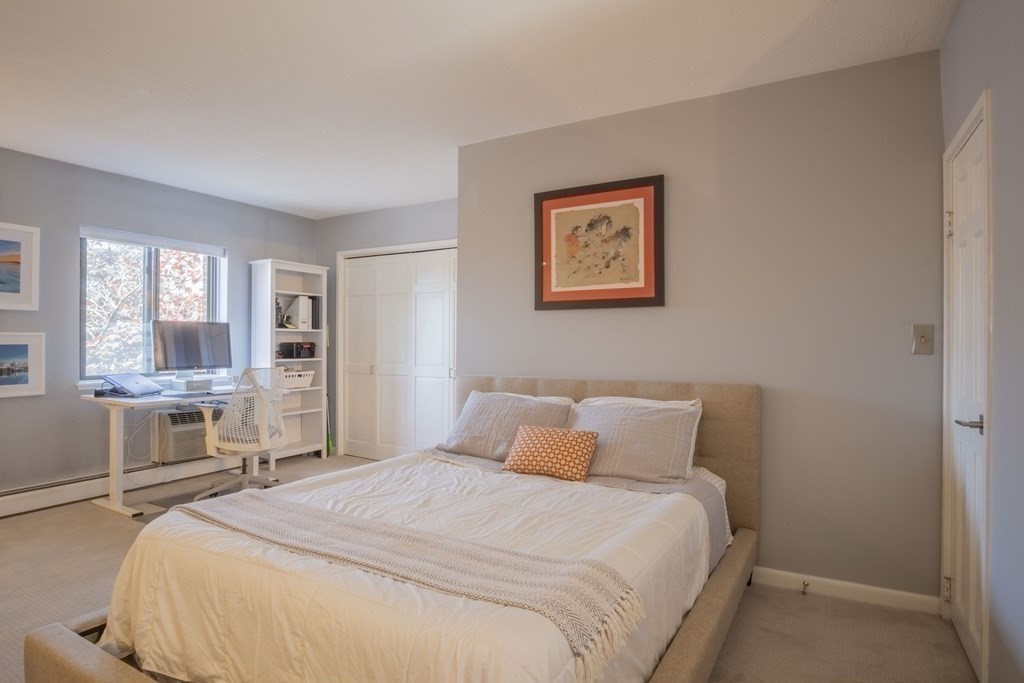 9 Barton Square, Unit 201 Salem, MA 01970 - Photo 30 of 42 a bedroom with a large bed and a window