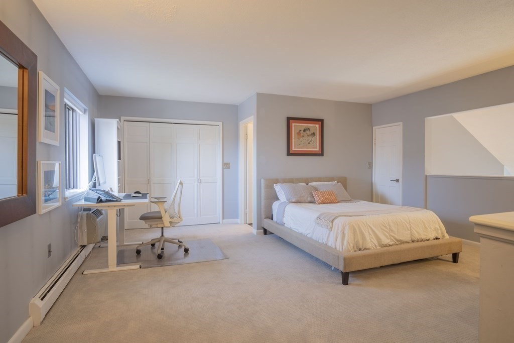 9 Barton Square, Unit 201 Salem, MA 01970 - Photo 31 of 42 a bedroom with a bed and a couch