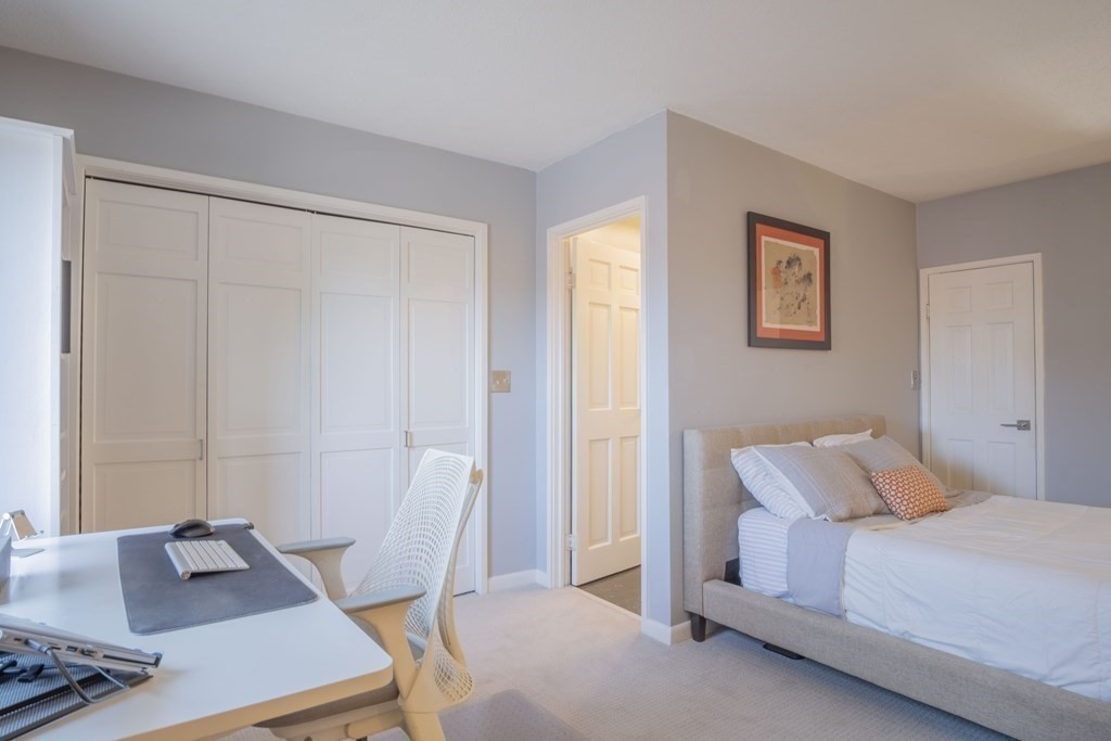 9 Barton Square, Unit 201 Salem, MA 01970 - Photo 32 of 42 a bedroom with a bed and a desk