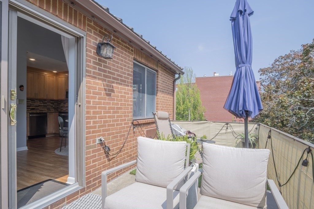 9 Barton Square, Unit 201 Salem, MA 01970 - Photo 36 of 42 a view of a patio with a table and chairs