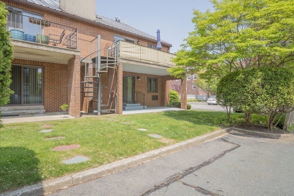 9 Barton Square, Unit 201 Salem, MA 01970 - Photo 38 of 42 front view of a house with a yard