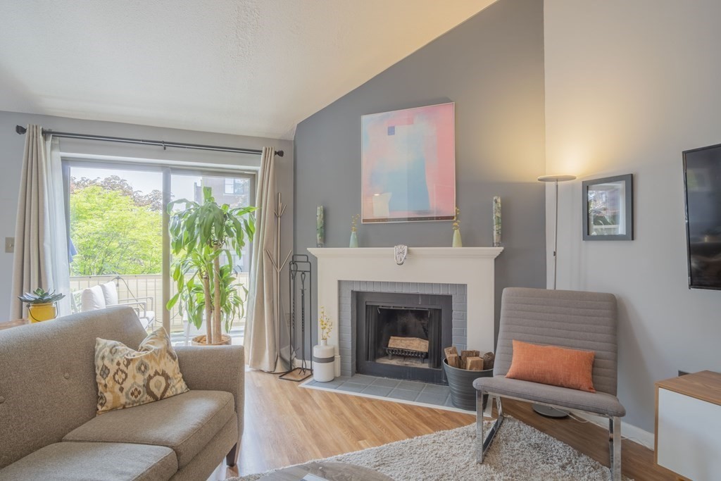 9 Barton Square, Unit 201 Salem, MA 01970 - Photo 4 of 42 a living room with furniture and a fireplace