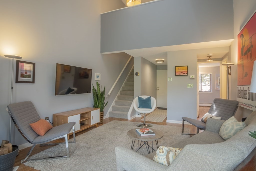 9 Barton Square, Unit 201 Salem, MA 01970 - Photo 7 of 42 a living room with furniture and a flat screen tv