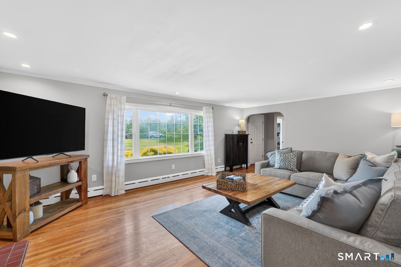1013 Ratley Road Suffield, CT 06093 - Photo 11 of 39 a living room with furniture and a flat screen tv