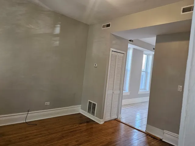 a view of a room with wooden floor