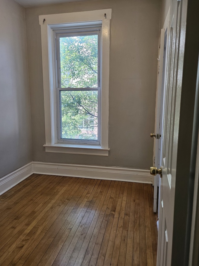 1025 West Cullerton Street, Unit 2F Chicago, IL 60608 - Photo 14 of 15 a view of a room with wooden floor and a window