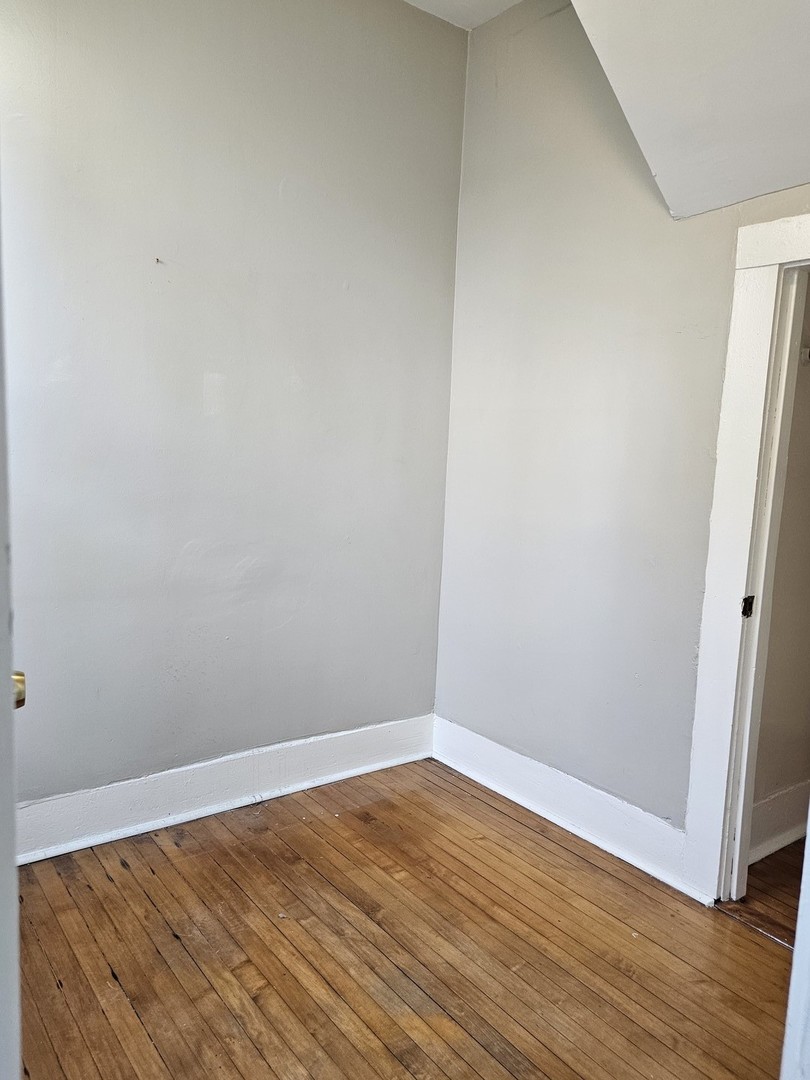 1025 West Cullerton Street, Unit 2F Chicago, IL 60608 - Photo 15 of 15 a view of an empty room with wooden floor