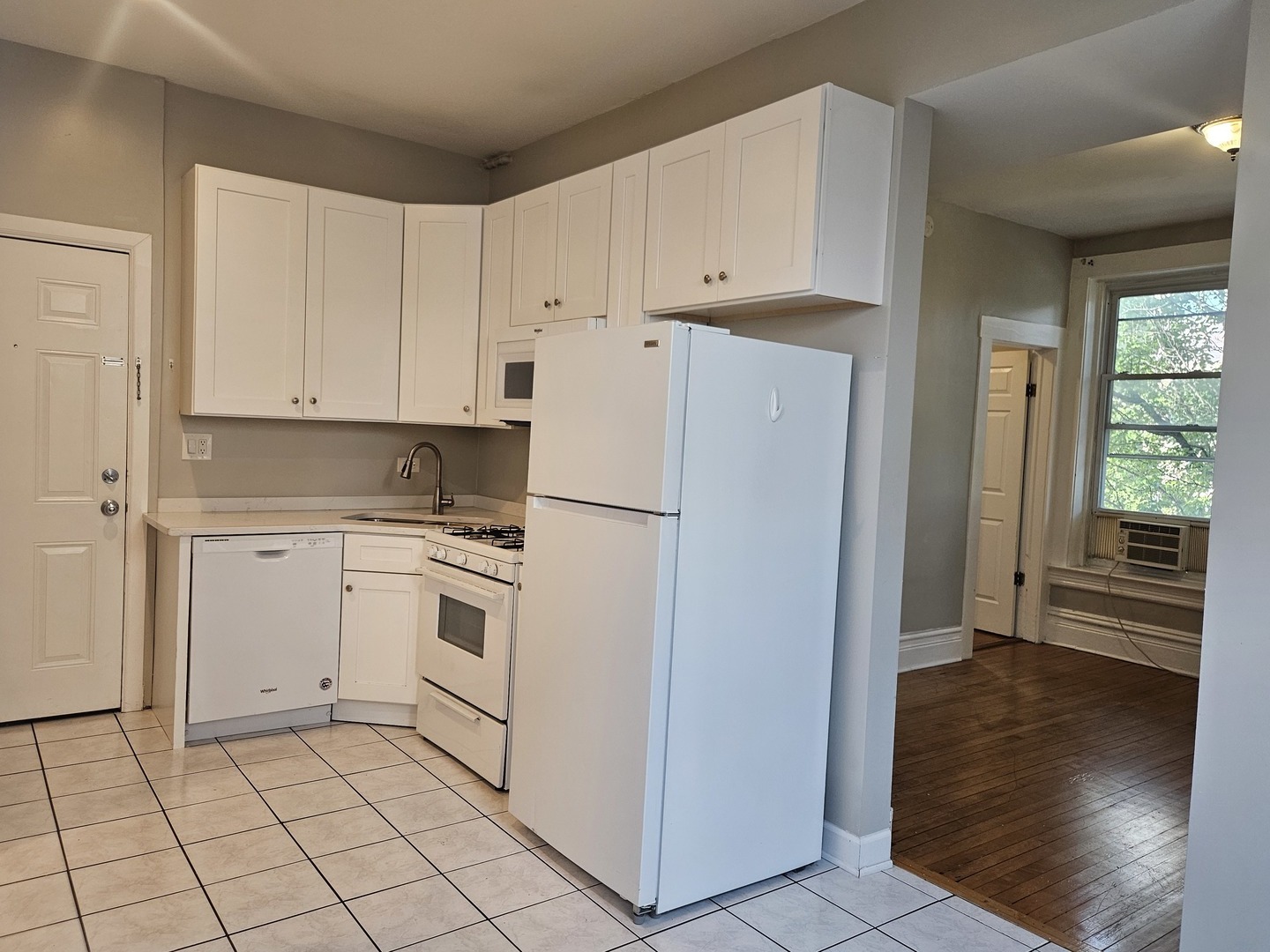 1025 West Cullerton Street, Unit 2F Chicago, IL 60608 - Photo 2 of 15 a kitchen with white cabinets and white appliances