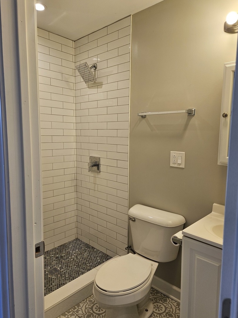 1025 West Cullerton Street, Unit 2F Chicago, IL 60608 - Photo 8 of 15 a white toilet sitting next to a bathroom sink