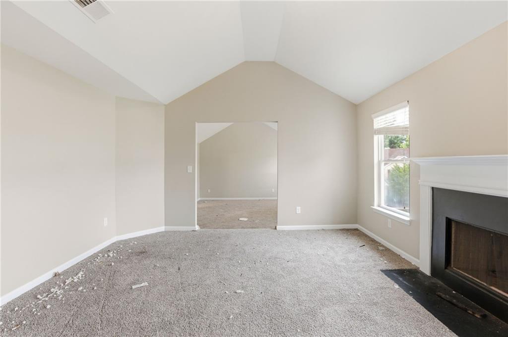 4968 Locherby Drive Fairburn, GA 30213 - Photo 24 of 39 a view of an empty room with window and fire place