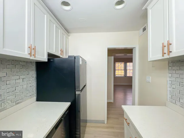 a kitchen with a refrigerator and a sink