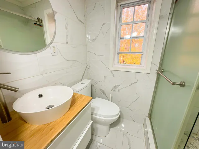 a bathroom with a toilet and a tub