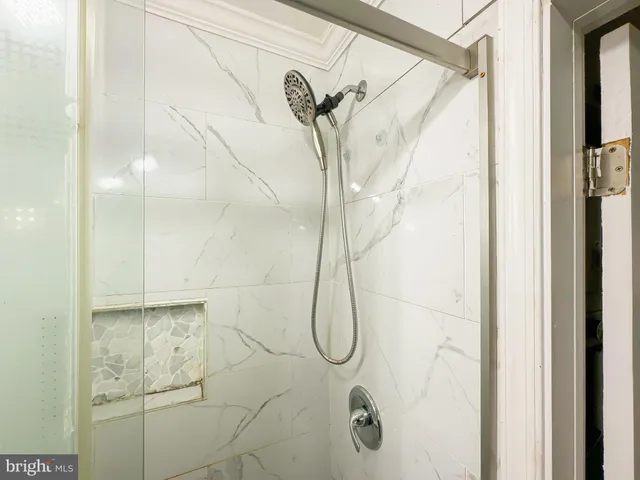 a bathroom with a glass shower door