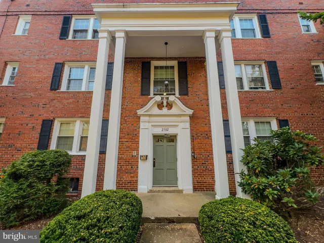 front view of a brick house with a large window