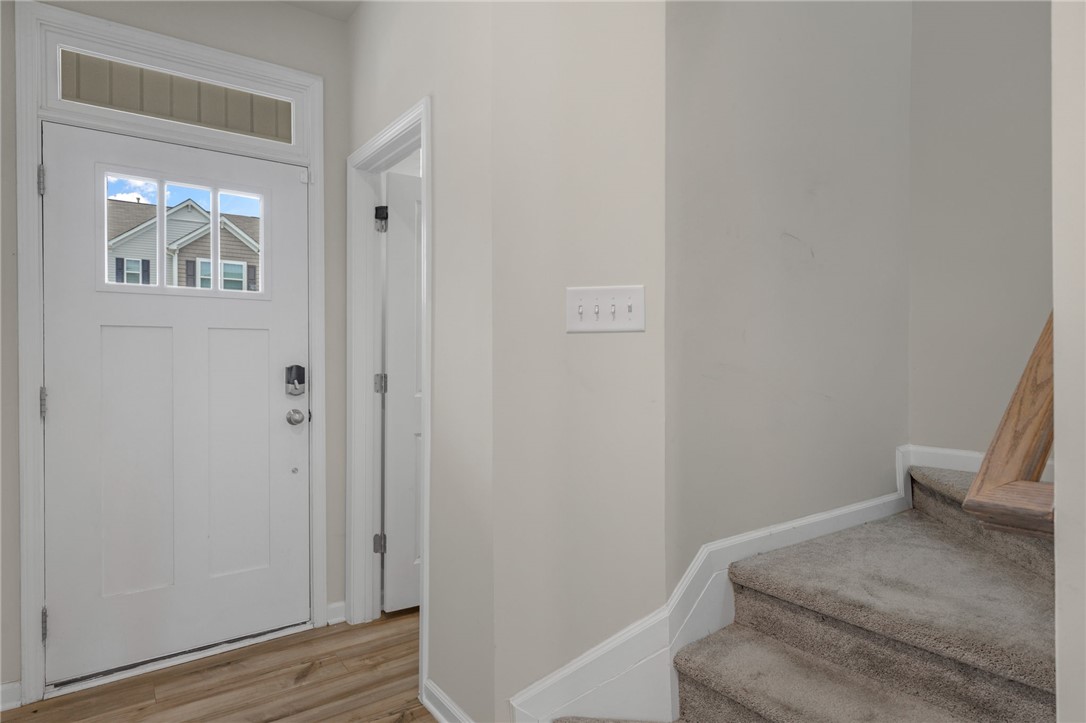 432 Bee Cv Way Pendleton, SC 29670 - Photo 7 of 39 This inviting entryway features a sturdy front door, beautiful floors, and a carpeted staircase leading to upper levels.