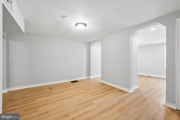 a view of an empty room with wooden floor