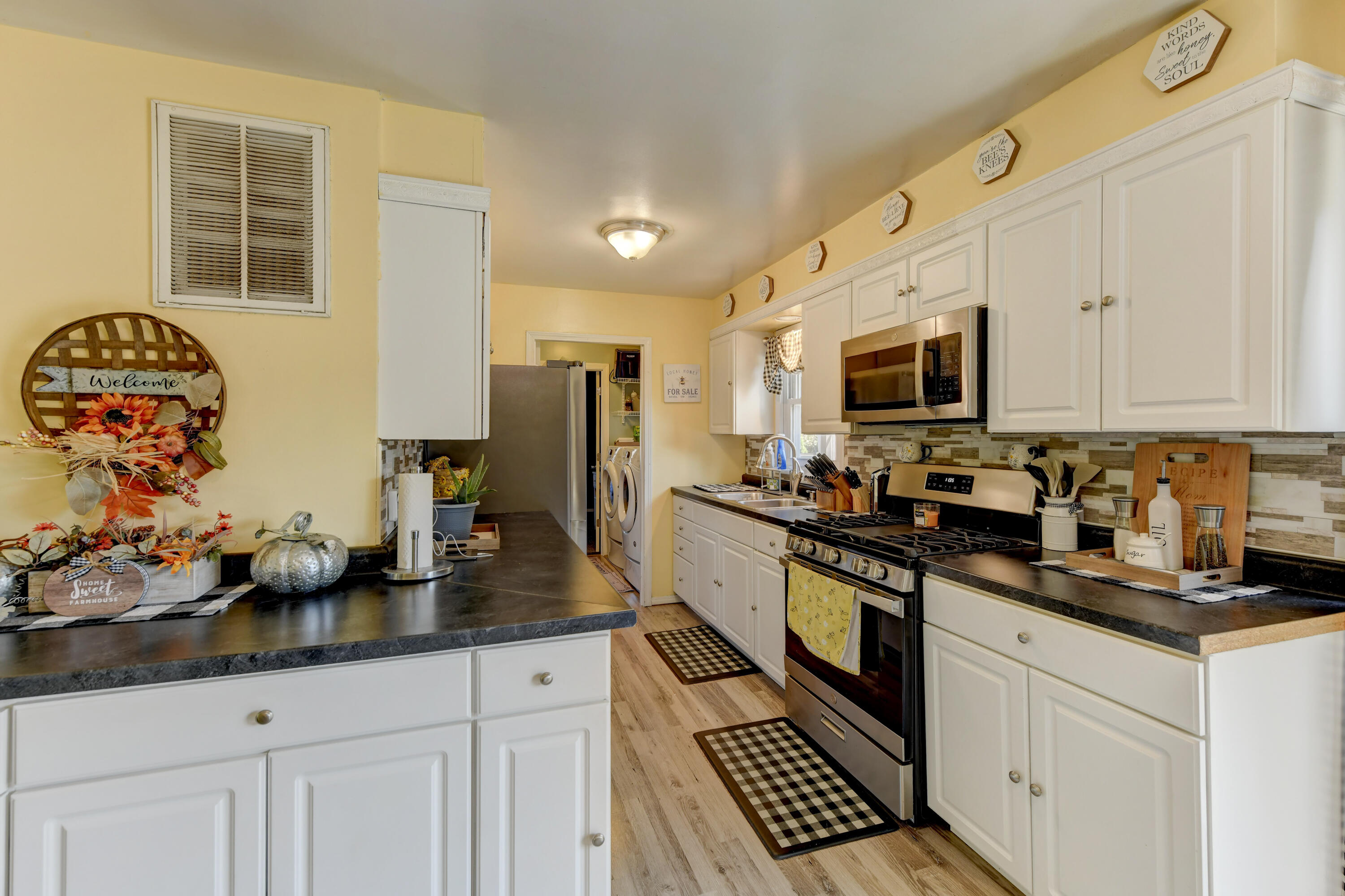 717 McCool Road Valparaiso, IN 46385 - Photo 4 of 18 a kitchen with stainless steel appliances a sink stove refrigerator and cabinets