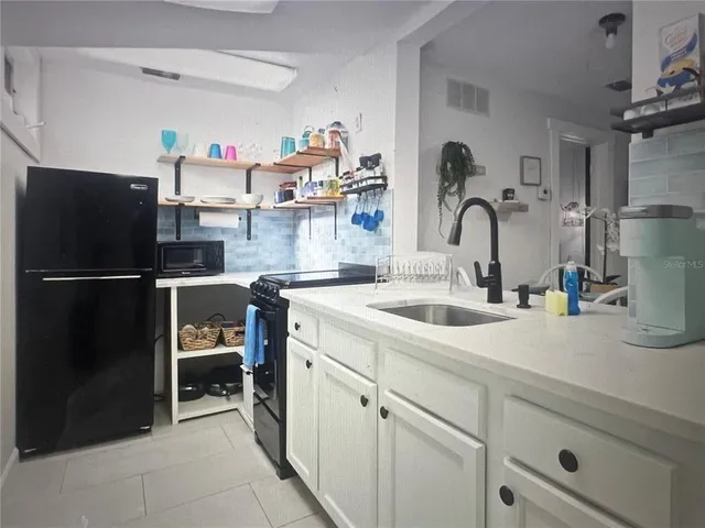 a kitchen with a refrigerator and a sink