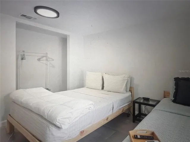a bedroom with a bed and a table