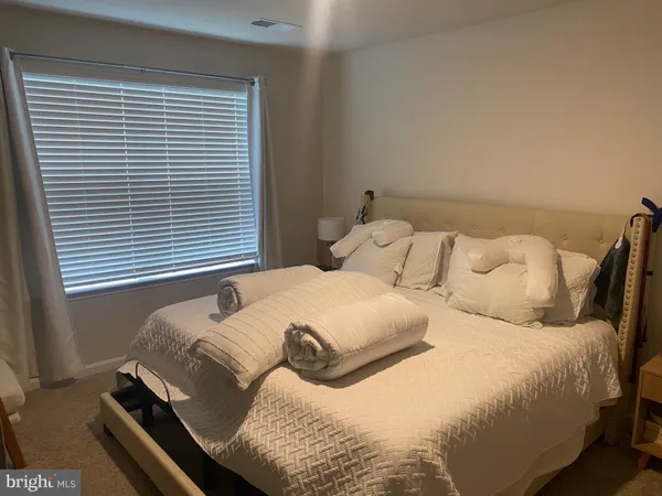 a bedroom with a bed and window