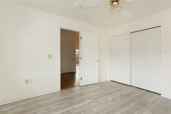 a view of an empty room with a ceiling fan