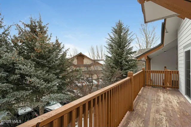 a view of a balcony with wooden fence