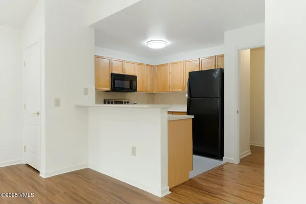 a kitchen with a refrigerator and a microwave