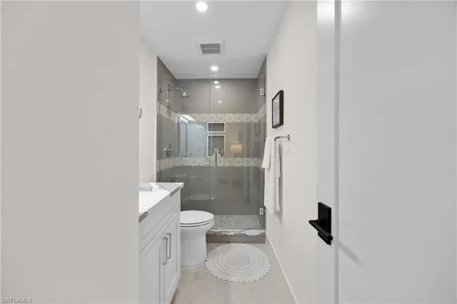 a bathroom with a toilet sink and shower