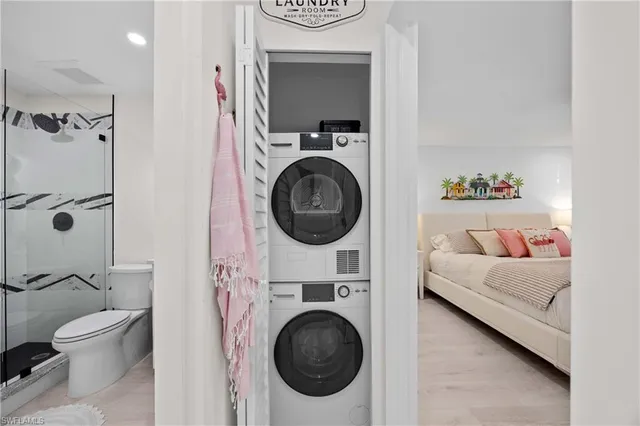 a view of a bedroom with washer and dryer