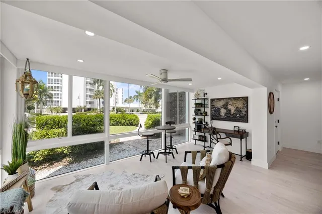 a living room with furniture and large windows