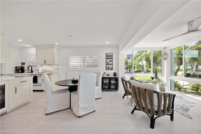 a kitchen with kitchen island granite countertop lots of counter top space and dining table