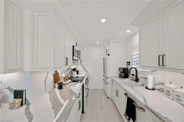 a kitchen with counter space sink stove and cabinets