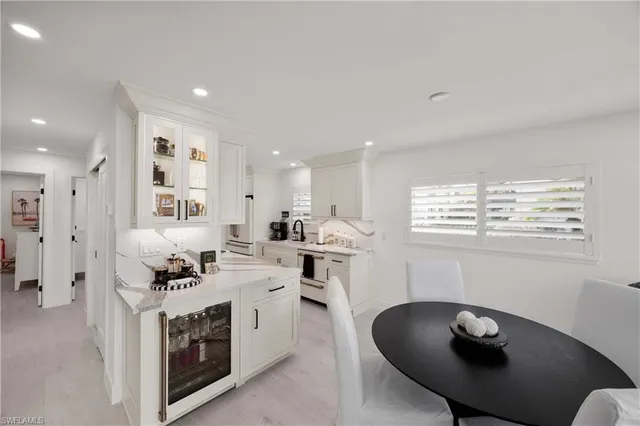 a kitchen with stainless steel appliances granite countertop a white cabinets and a stove top oven