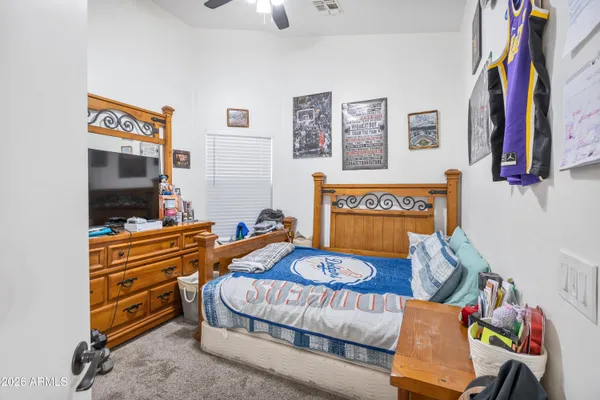 a bed room with a bed and a television