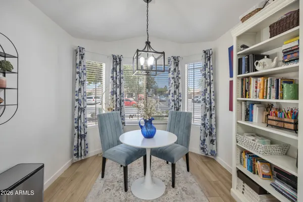 a dining room with furniture a book and wooden floor