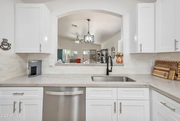 a view of living room with granite countertop furniture and a kitchen view