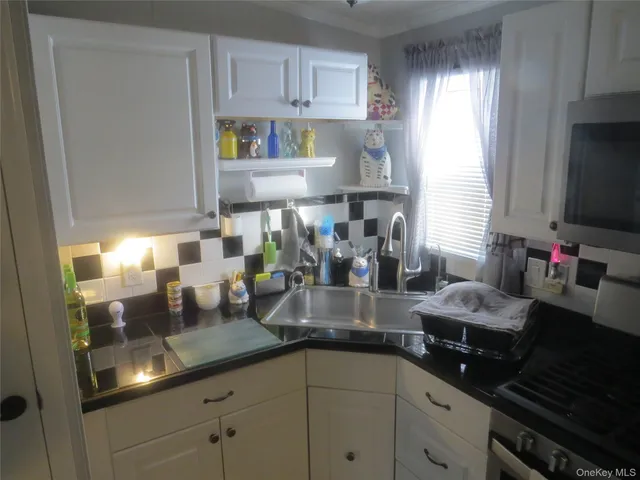 a kitchen with a sink and cabinets