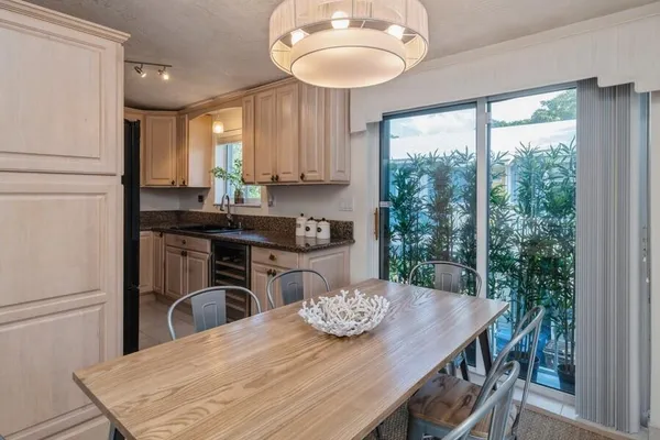a kitchen with a table chairs and refrigerator