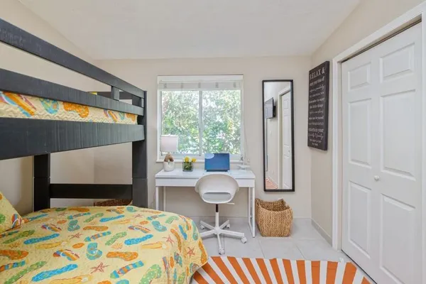 a bedroom with a bed and a large window