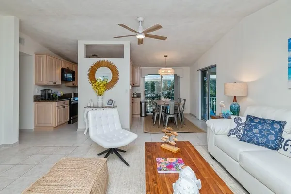 a living room with furniture a rug and a chandelier