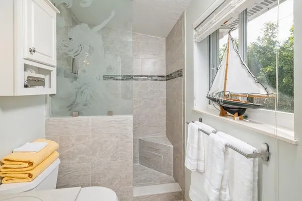 a bathroom with a sink mirror vanity and toilet