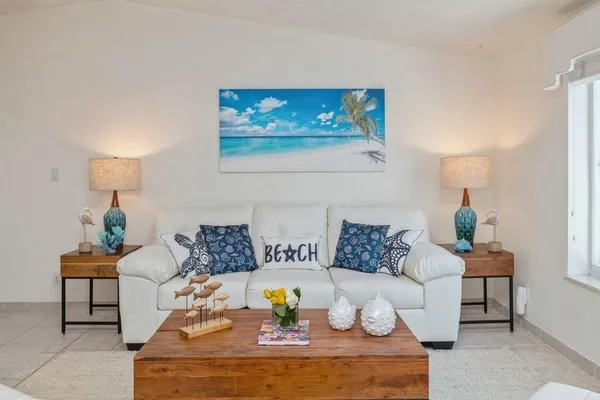 a living room with furniture and a lamp