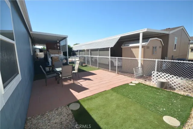 a backyard of a house with table and chairs