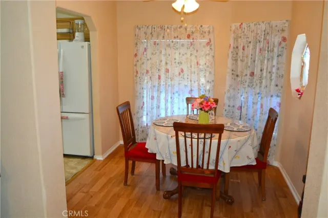 a view of a dining room with furniture wooden floor and a chandelier
