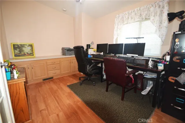 a view of a workspace with furniture and a window